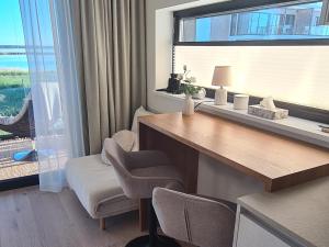 a room with a desk and a chair and a window at Seaside Getaway Apartment in Haapsalu