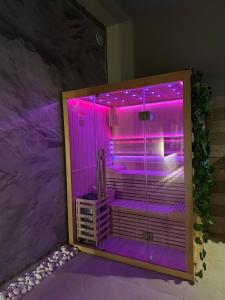 a shower with purple lighting in a room at BREATH47SPA - Private Spa Suite White Jacuzzi & Sauna in Marbella in Marbella