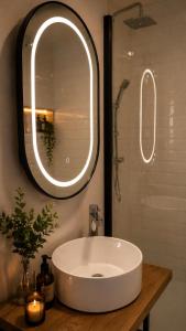 a bathroom with a white sink and a mirror at Maisonette Wohnung WALDLOFT in Mehlmeisel +26 photos