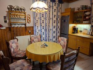 a dining room with a table and chairs and a kitchen at Haus Rieder in Wörgl