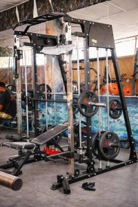 a gym with a weight lifting machine with weights at Airport Side Hotel in Accra