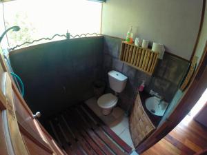a small bathroom with a toilet and a sink at Tampat do Aman in Kudat