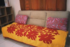 a bed with two pillows on top of it at Vahinui lodge in Bora Bora