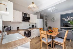 a kitchen and living room with a table and chairs at Artemis' Garden in Skopelos Town