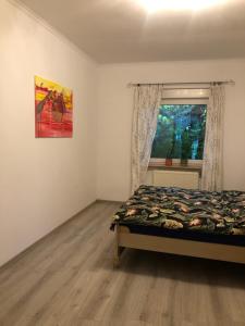 a bedroom with a bed and a window at Apartament Cozy Studio in Żagań