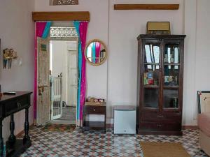 a living room with a door and a table and a mirror at DanCenter Kolpol by CheckIn Udaipur in Udaipur +38 photos
