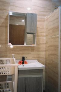 a bathroom with a white sink and a mirror at Vahinui lodge in Bora Bora +11 photos