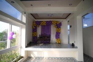 a room with a balloon wall in a room with windows at Hotel Joy Guru Inn in Durgāpur
