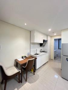 a kitchen with a table and chairs and a refrigerator at Tian Yue Hotel in Phnom Penh