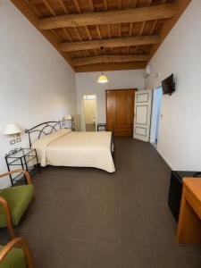 a large bedroom with a bed and a kitchen at Riolo Terme Camere in Riolo Terme