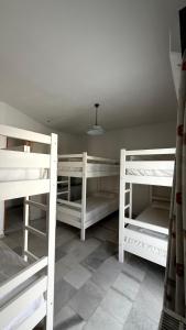 a room with three bunk beds and a ceiling at Naxos City Hostel in Naxos Chora