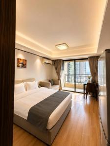 a bedroom with a large bed and a large window at Tian Yue Hotel in Phnom Penh +7 photos
