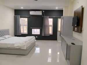 a bedroom with a white bed and a black wall at NestIN hotels in Lucknow +15 photos