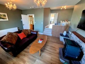 a living room with a couch and a table at Cuchulainn Townhouse in Galway +64 photos