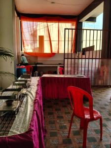 a room with a table and a red chair at NestIN hotels in Lucknow