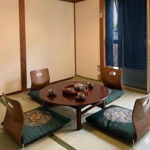 a dining room with a table and chairs and a window at Hirakata house, Easy Access to Kyoto and Osaka in Hirakata