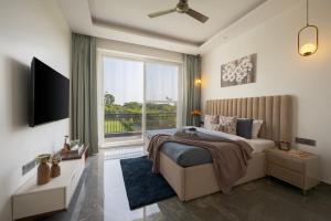 a bedroom with a large bed and a large window at Saffronstays Olive Farms in Mandkaula +14 photos