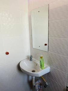 a bathroom with a sink and a mirror at The Crown Stay in Machakos