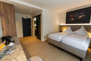a hotel room with a bed and a table at Hotel Sittardsberg in Duisburg