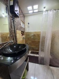a bathroom with a black sink and a shower at Agora Home in Wonosobo +46 photos