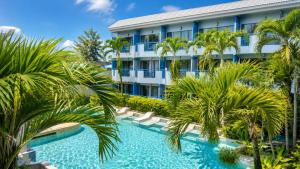 a resort with palm trees and a swimming pool at Phuket Island View Resort in Karon Beach