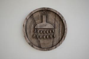 a wooden plate with a computer mouse on a wall at Jahta Engures ostā in Engure