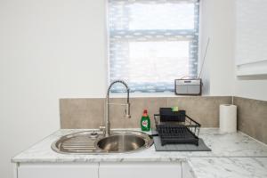 a kitchen counter with a sink and a window at The Belmont Suits in Liverpool +38 photos