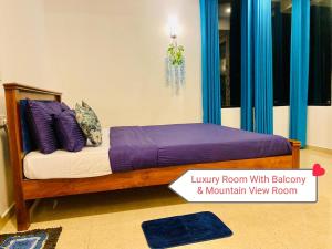 a bedroom with a bed with purple sheets and pillows at Rock Face Palace in Ella +60 photos