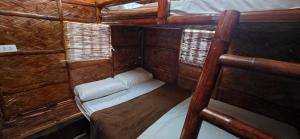 a small room with a bed in a cabin at RMB's Downton Place in Tagaytay +11 photos