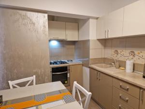 a small kitchen with a table and a sink at Iris ultracentral apartment in Mangalia