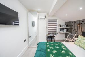 a bedroom with a bed and a living room at The Belmont Suits in Liverpool