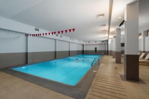 a large swimming pool in a building at Ani Plaza Hotel in Yerevan