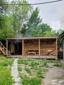 a wooden cabin with a pathway leading to it at Дом твоей силы in Talghar