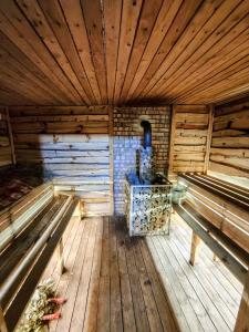 an inside view of a wooden cabin with a stove at Дом твоей силы in Talghar +1 photo