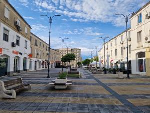 an empty city street with benches and buildings at Iris ultracentral apartment in Mangalia