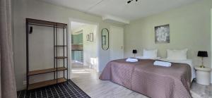 a bedroom with a large bed and a bathroom at Glaskogen Holiday Homes in Glava