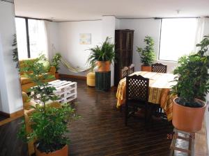 a room with potted plants and a table in it at Edificio Foch in Quito