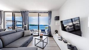 a living room with a couch and a tv at Villa Evia by Villas Guide in Smokvica
