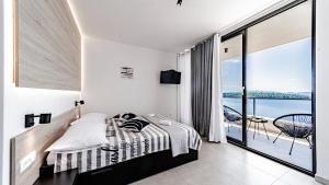 a bedroom with a bed and a view of the water at Villa Evia by Villas Guide in Smokvica +38 photos