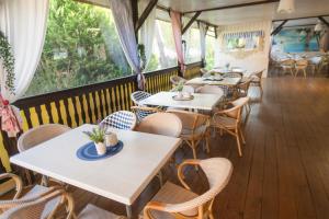 a row of tables and chairs in a restaurant at Pensjonat PISZ in Pobierowo +15 photos