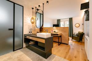 a bathroom with a sink and a mirror at Arlbergerhof Vital in Weissensee