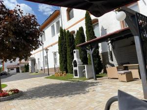 a building with a pavilion in front of a street at Penzion B5 in Kežmarok