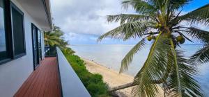 a view of the beach from the balcony of a house at Toreaiva 91 Beachfront Studios in Arorangi +8 photos