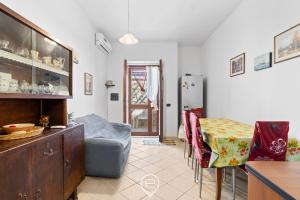 a kitchen with a table and a refrigerator at Estay - Zoe&Perla - Exclusive vacation near the beach in S'archittu Cuglieri