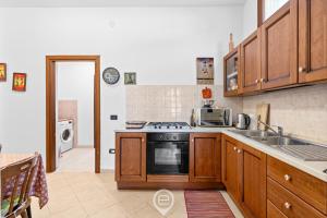 a kitchen with a stove and a sink at Estay - Zoe&Perla - Exclusive vacation near the beach in S'archittu Cuglieri