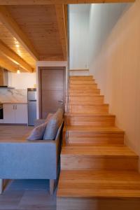 a living room with a couch and wooden stairs at Casa Ataraxia II in Boiro +8 photos