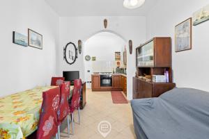 a kitchen and dining room with a table and chairs at Estay - Zoe&Perla - Exclusive vacation near the beach in S'archittu Cuglieri