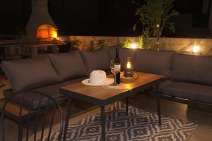 a couch and a table with a candle on it at PaCha Boutique house in Novalja