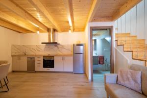 a kitchen with a refrigerator and a staircase at Casa Ataraxia II in Boiro