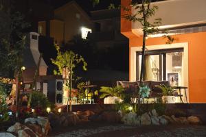 a house with a couch in front of a window at night at PaCha Boutique house in Novalja